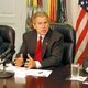 Flanked by Condoleezza Rice and Donald Rumsfeld, President Bush pledges to "exact revenge, just as soon as we know who we're exacting revenge against and where they are."